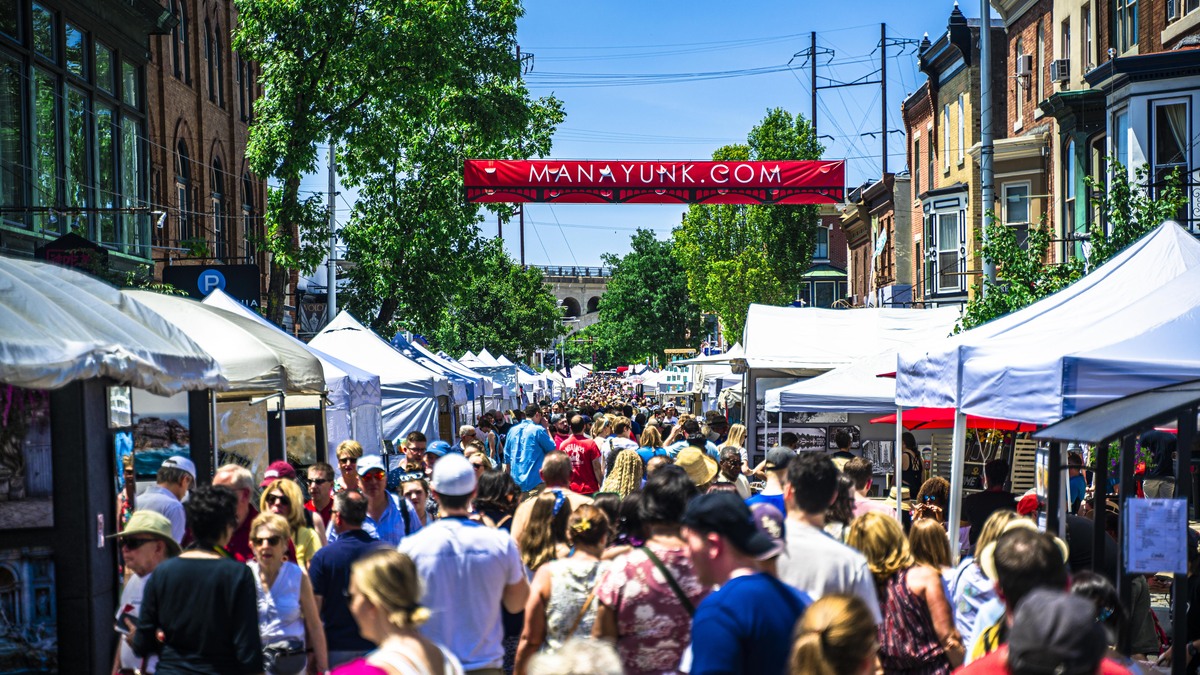 Patron walking down main street during Arts Festival