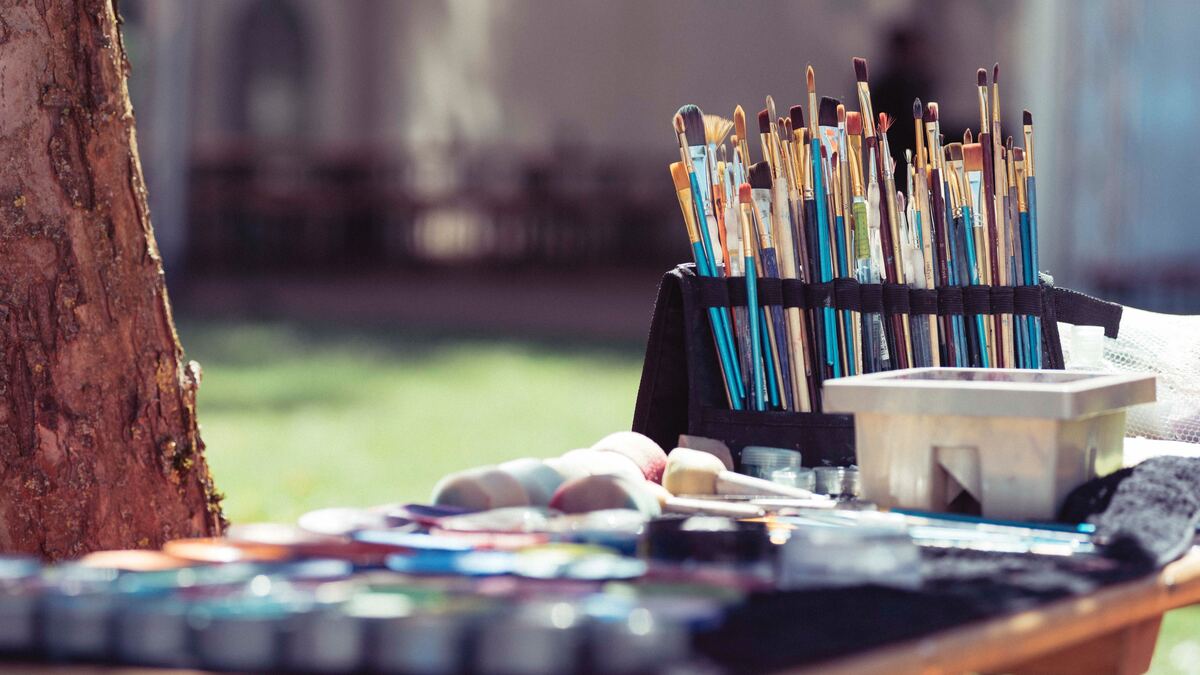 Table with paint and paintbrushes