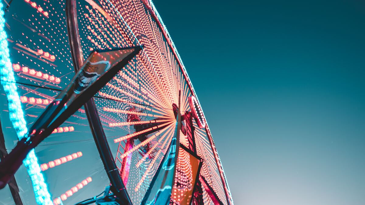 Ferris wheel at dusk with red and blue lights