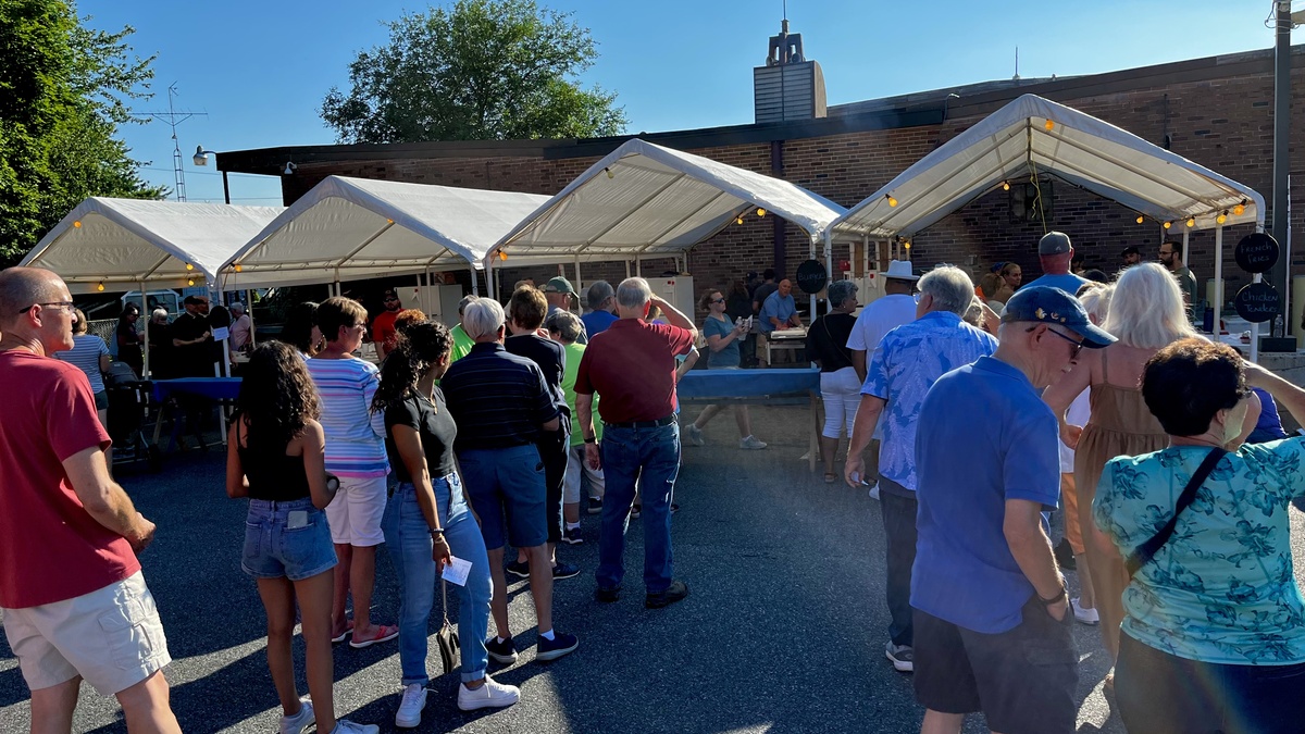 Attendees in line for food at festival grounds.